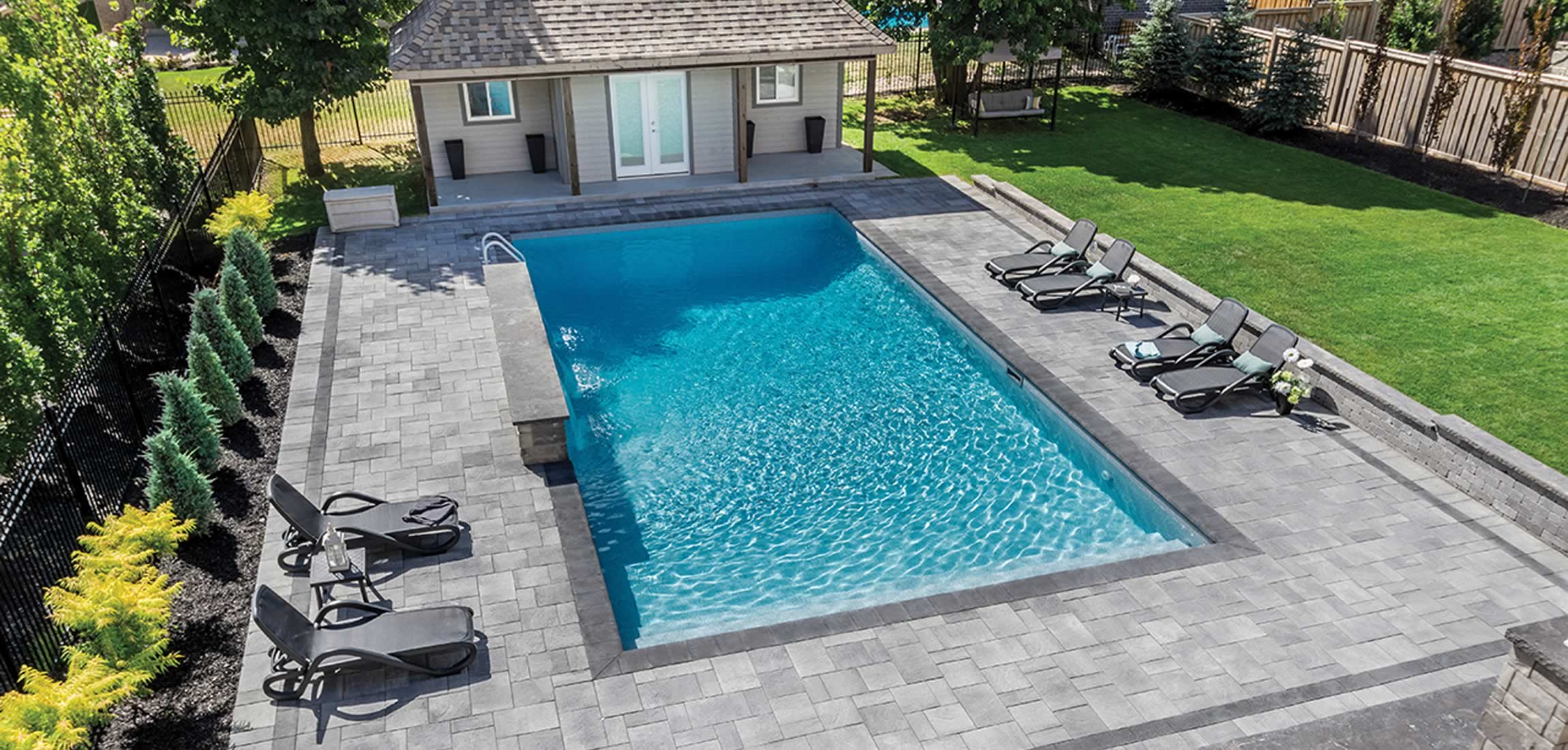 Image of a pool and surrounding stone patio