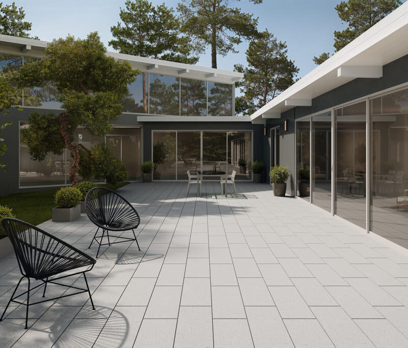 Modern outdoor patio featuring Lyra NanoBlast concrete pavers with a refined textured surface.