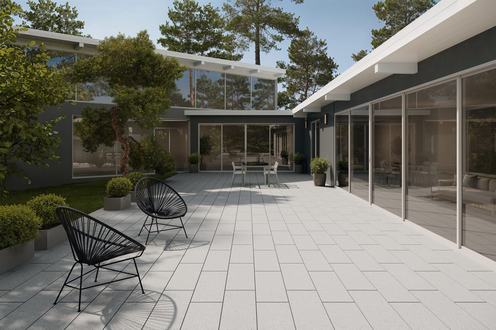 Modern outdoor patio featuring Lyra NanoBlast concrete pavers with a refined textured surface.